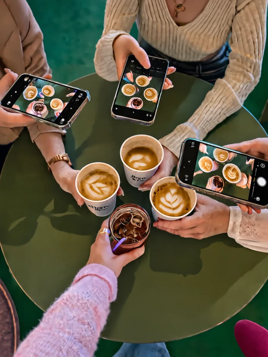 Friends photographing coffee